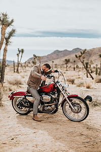 man riding red cruiser motorcycle thumbnail