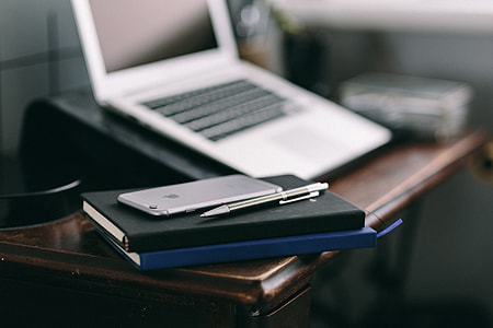 Elegant workspace with Macbook, iPhone, business cards and notebooks thumbnail