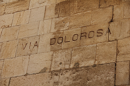 closeup photo of gray concrete wall with VIA Dolorosa carved thumbnail