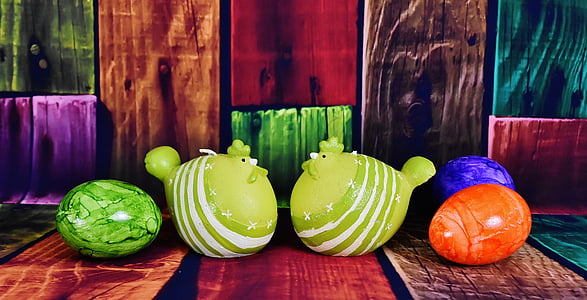 green rooster figurines facing each other thumbnail
