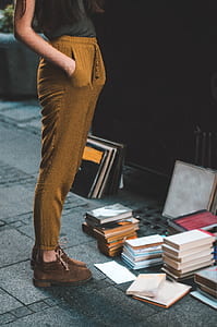 person wearing brown jogger pants facing assorted photo frames thumbnail