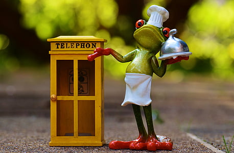 selective focus photography of frog waiter beside telephone booth miniature thumbnail