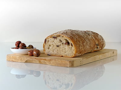 glazed bread on brown wooden chopping board thumbnail