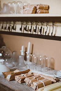 paper wrapped taper candles on brown wooden shelf thumbnail