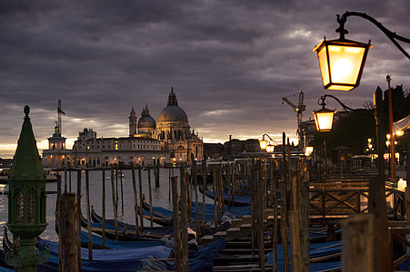 boats in marina in front of mosque structure over cloudy skies thumbnail