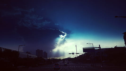 blue clouds on top of highway thumbnail