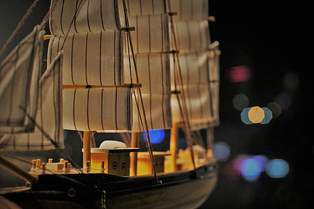 closeup photo of brown and black wood ship model with bokeh background thumbnail