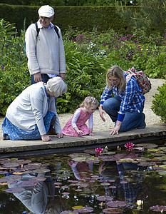 woman wearing blue denim pants beside girl wearing pink dress during daytime thumbnail