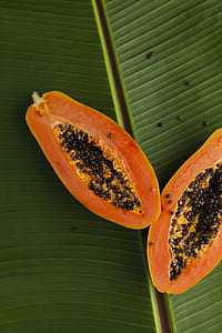 sliced papaya on green banana leaf thumbnail