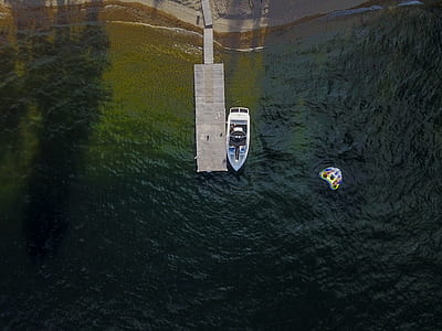 aerial photography of yacht near wooden dock thumbnail