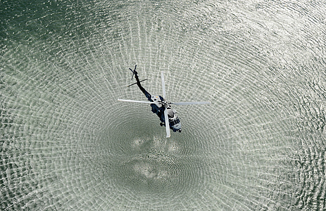black helicopter forming water ripple thumbnail