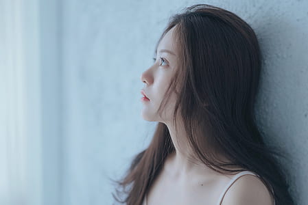 woman leaning on white wall thumbnail