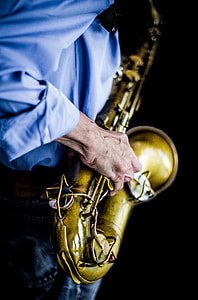 person wearing blue dress shirt playing brass saxophone thumbnail