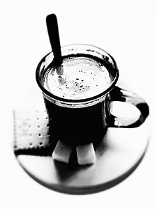 grayscale focus photography of cup on saucer with biscuits thumbnail