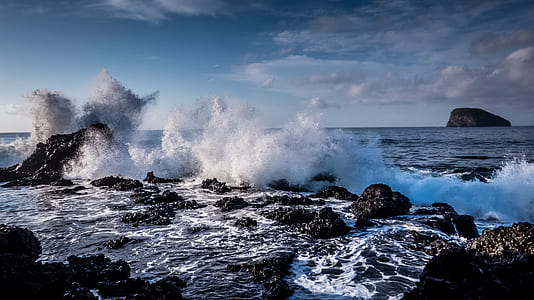 body of water near rock formation thumbnail