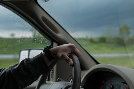 person driving car under dark sky thumbnail