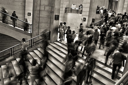 greyscale photo of people walking on stairs thumbnail