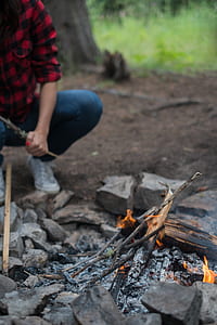 person in blue denim pants burning woods thumbnail