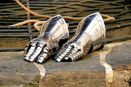 pair of silver gauntlets on gray surface thumbnail