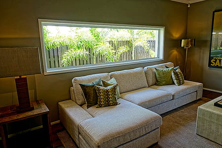 gray fabric sectional sofa near square brown wooden end table thumbnail