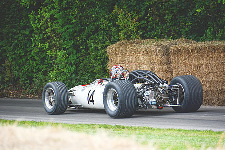 closeup photography of white and black modified car running on road near brown hays during daytime \ thumbnail