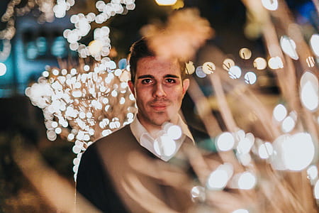 bokeh photography of man in black V-neck top thumbnail