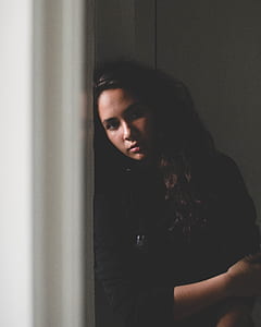 woman leaning head on wall thumbnail