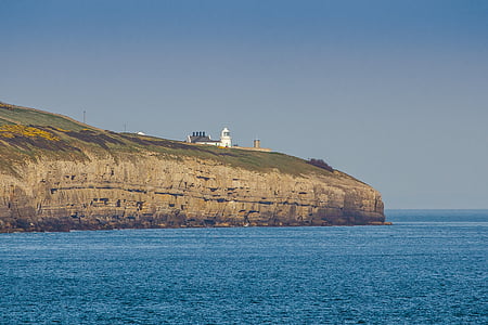 lighthouse near a cliff thumbnail