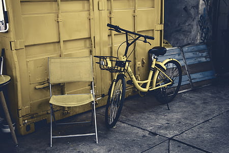 bike beside chair and intermodal container thumbnail