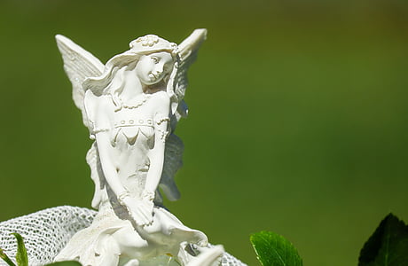 white ceramic angel figurine in closeup photography thumbnail