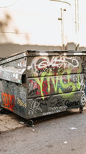 gray and multicolored garbage bin with graffiti thumbnail