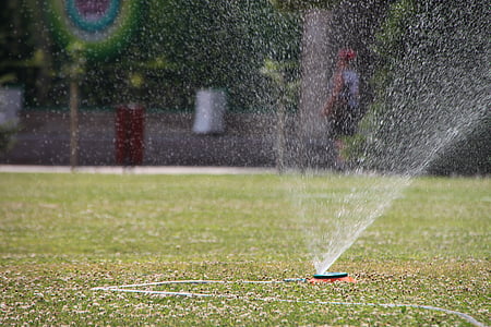 water sprinkler on field at daytime thumbnail