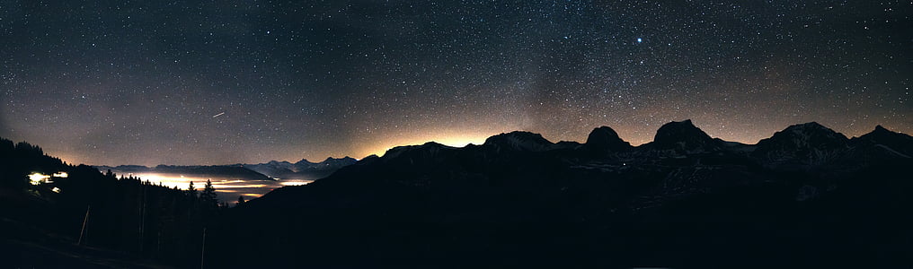 panorama photo of mountain with trees during nighttime thumbnail