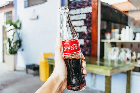 person holding Coca-Cola bottle thumbnail