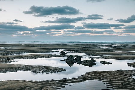 body of water beside stones thumbnail