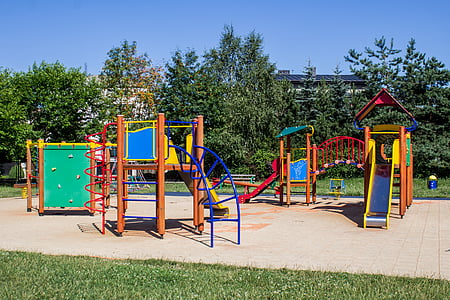 playground beside treeline during daytime photo thumbnail