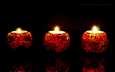 three lighted tealight candles thumbnail