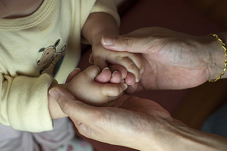 person holding toddler hands thumbnail