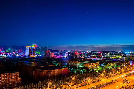 aerial view photography of concrete buildings at night time thumbnail