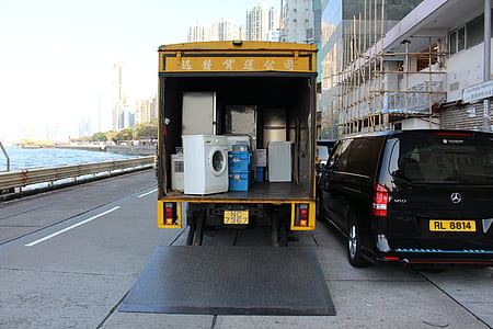 yellow moving truck with appliances thumbnail