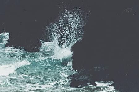 ocean wave crashing on rock formation thumbnail