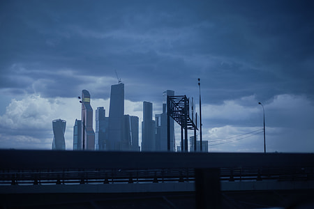 architectural photography of cityscape under cloudy sky during daytime thumbnail