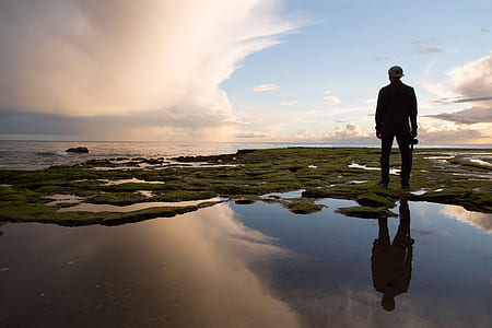 man standing beside sea thumbnail