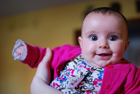 baby in white and pink shirt close up photo thumbnail