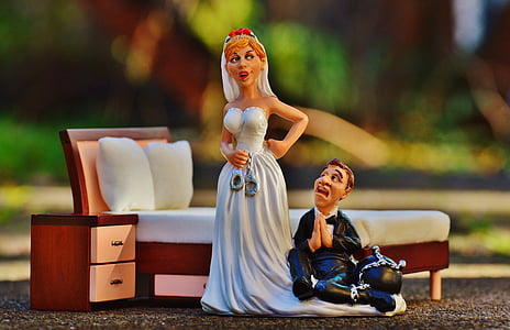 married couple figurine beside bed frame selective focus photography thumbnail