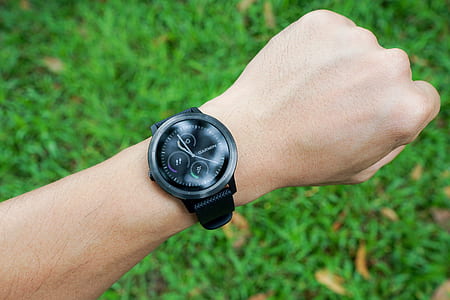 person wearing round black chronograph watch at 10:59 thumbnail