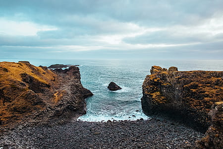 body of water between two rocky cliffs thumbnail