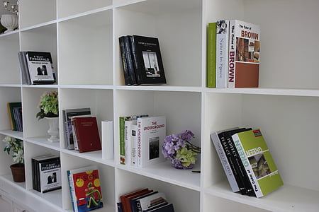 books in white wooden cubby shelf thumbnail