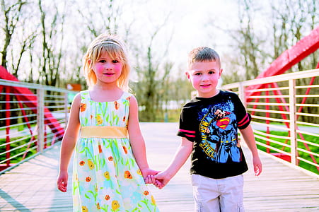 boy and girl holding their hand during daytime thumbnail