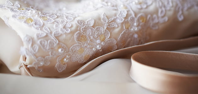 white floral lace dress on white textile thumbnail